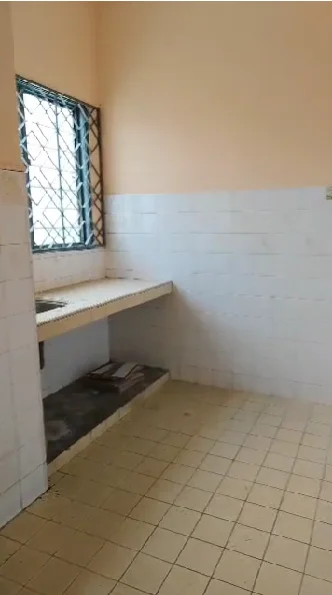 Laundry features: single-bowl sink, countertop with storage space, white tiled walls, cream painted walls, yellow tiled flooring, metal window grilles, natural light from window.